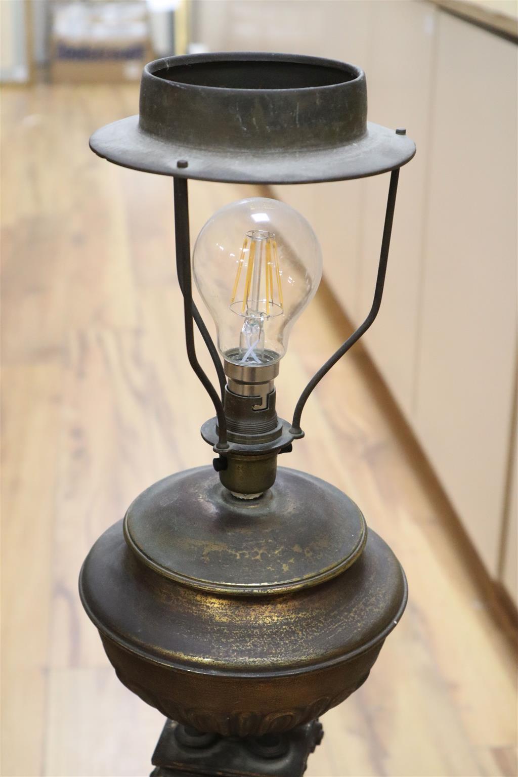 A 19th century gilt bronze and brass oil lamp on tri-form dragon supports (converted for electricity)